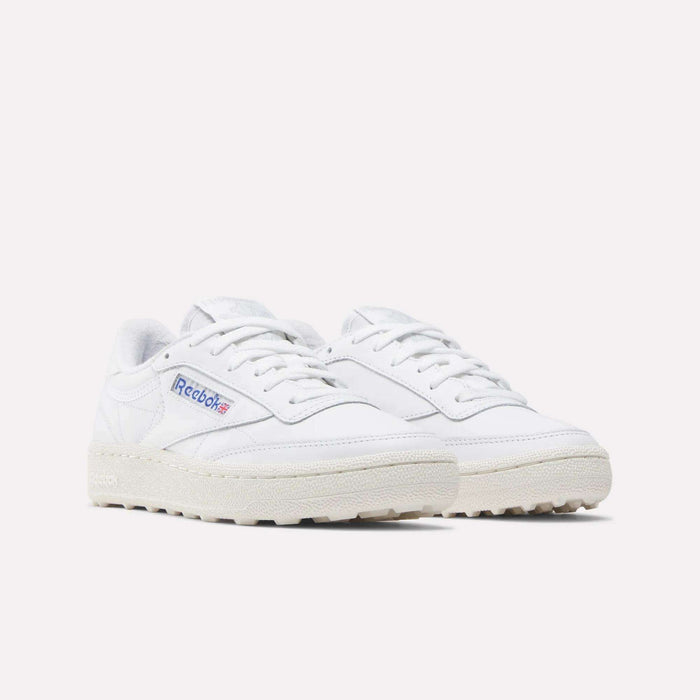 Reebok Women's Club C Golf Shoes in white with off-white soles and blue-red Reebok logo on the side, featuring a spikeless outsole for grip—ideal women's golf shoes, shown on a light background.