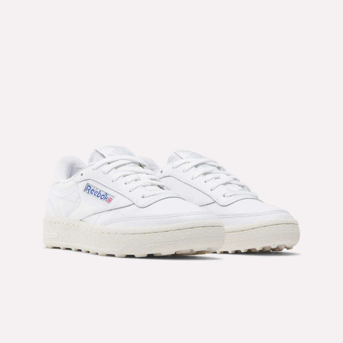 Reebok Women's Club C Golf Shoes in white with off-white soles and blue-red Reebok logo on the side, featuring a spikeless outsole for grip—ideal women's golf shoes, shown on a light background.