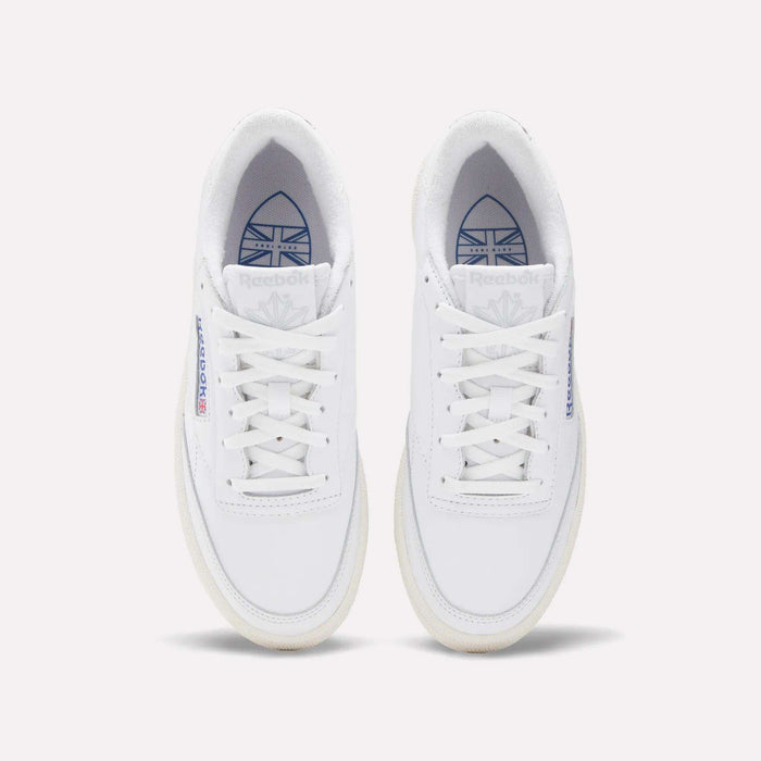 Top view of Reebok Women's Club C Golf Shoes in water-resistant leather, featuring white sneakers with blue and red branding on the tongue and side, displayed side by side on a plain white background.
