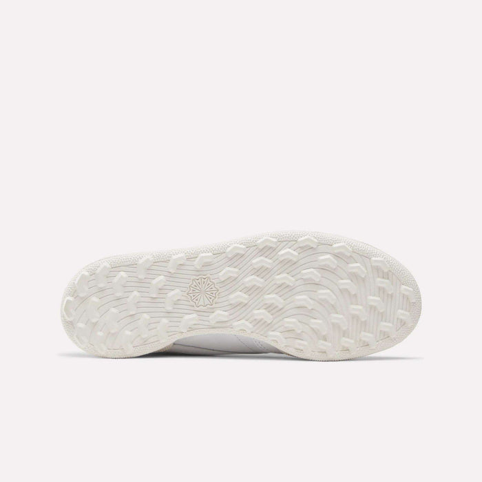 The image shows the bottom view of the Reebok Women's Club C Golf Shoes, highlighting a spikeless outsole with a textured, wavy tread pattern and a star-shaped design in the center.
