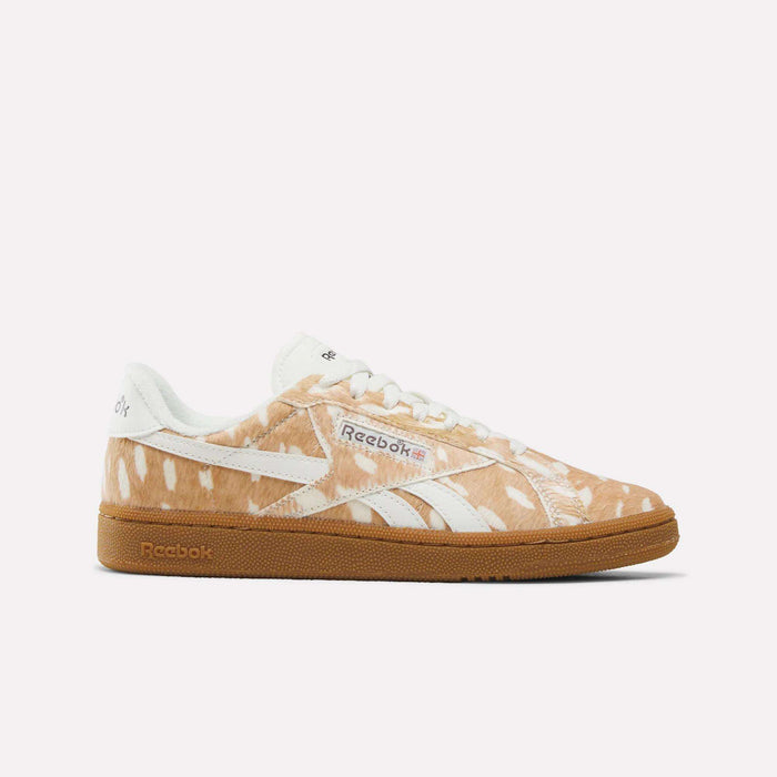 The Women’s Club C Grounds UK 1.0 Shoes by Reebok, shown in a Brown/White/Gum colorway with an animal print pattern, white laces, signature Reebok branding in white, and a gum-colored sole, are displayed against a plain white background.