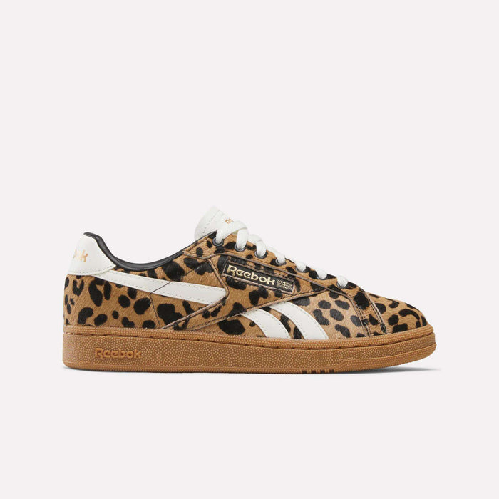 The Women's Club C Grounds UK Shoes by Reebok feature a leopard print pony hair upper, white stripes, and a brown gum sole—shown here against a plain white background.