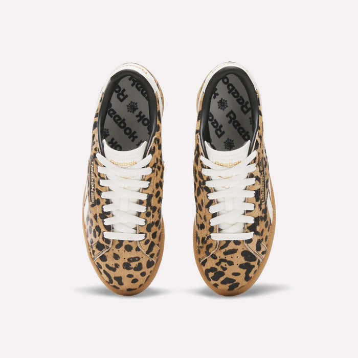 A pair of Reebok Women's Club C Grounds UK Shoes with a tan and black leopard print, white laces, and black Reebok insoles is seen from above on a plain white background.