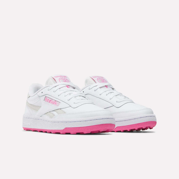 A pair of Reebok Women’s Club C Revenge Golf Shoes in white, featuring pink soles and pink Reebok logo accents on the sides and tongue, displayed against a plain light background.