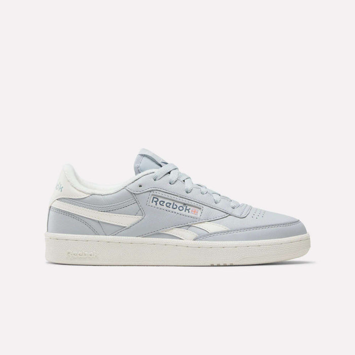 A pair of Women's Club C Revenge Shoes by Reebok in the Breeze/Chalk/Breeze colorway, featuring a classic side profile with vintage court-inspired style, white sole, subtle light blue accents, and a white Reebok logo, is presented against a plain white background.