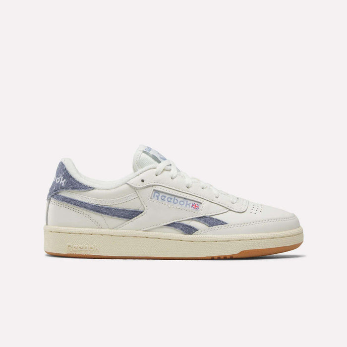 The Reebok Women's Club C Revenge Shoes feature a white design with blue accents, beige sole, and Reebok logos on the side and heel, shown in side profile against a plain white background—ideal for fans of classic women's court shoes.