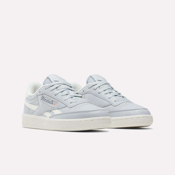 A pair of Women's Club C Revenge Shoes by Reebok in light gray, featuring white soles and white accents, are displayed on a plain white background—offering the perfect blend of vintage court style and casual women's footwear.