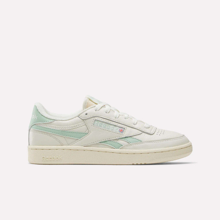 The Reebok Women's Club C Revenge Vintage Shoes are shown in cream with light green accents, displaying the Reebok logo and British flag in a side profile against a white background, echoing classic vintage style.