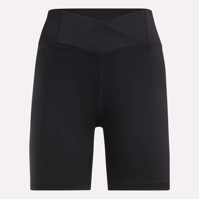 Reebok Women's Core High-Rise Cycle Shorts feature a black, sweat-wicking fabric, crossover waistband, and mid-thigh length. Displayed on a plain light background.
