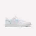 A side profile of the Reebok Women’s Court LXS Shoes in White/Digital Blue is shown against a plain white background. These low-top shoes, made from premium full grain leather, feature subtle digital blue branding and stitching details—ideal for anyone seeking stylish women’s court shoes with classic appeal and quality craftsmanship.
