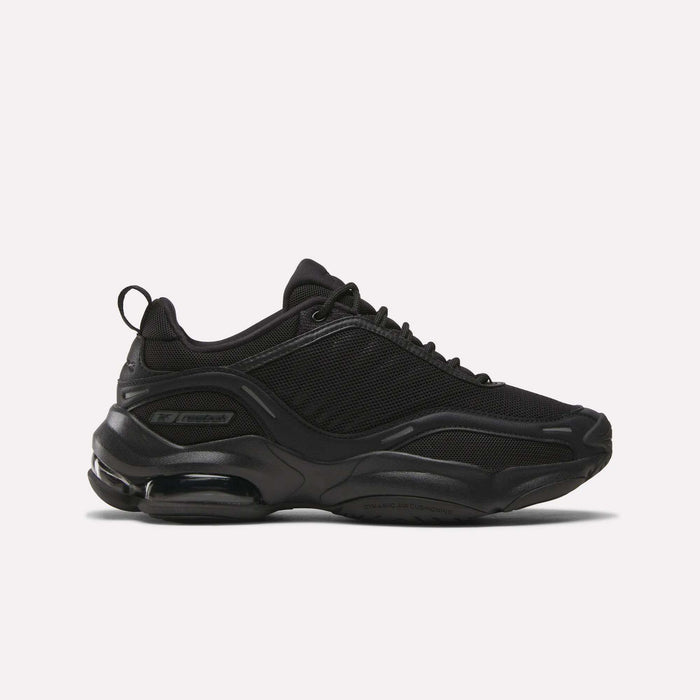 The Women's DMX Series 3000 Training Shoes by Reebok feature a black mesh and synthetic upper, chunky sole, lace-up front, and visible DMX 3 Technology air cushioning in the heel. Shown on a white background—perfect as advanced Reebok walking shoes.