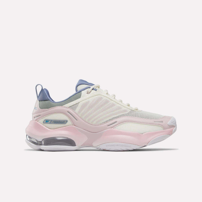 Step out in style and comfort with the Reebok Women's DMX Series 3000 Training Shoes, featuring a breathable white mesh upper highlighted by elemental pink and legacy green accents, plus a chunky sole with transparent heel sections. These standout sneakers incorporate advanced DMX 3 Technology for a responsive stride—perfect for those seeking cushioned shoes that combine eye-catching design with lasting comfort.