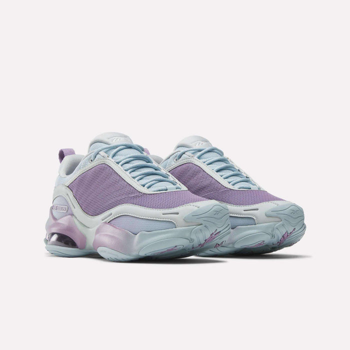 Step out in style with Reebok Women's DMX Series 3000 Training Shoes, featuring chunky light blue soles, purple mesh uppers, pastel blue and lavender accents, DMX 3 Technology cushioning, and a modern sporty design.