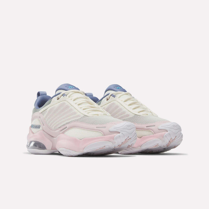 The Reebok Women's DMX Series 3000 Training Shoes feature white mesh uppers with light pink and beige accents, blue details on the tongue and heel, chunky white soles with visible air cushioning, and advanced DMX 3 Technology—offering cushioned comfort and support for a superior walking experience.