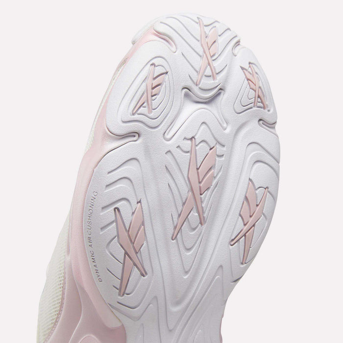 Close-up view of the sole on the Reebok Women's DMX Series 3000 Training Shoes, featuring a textured white design with light pink accents. Inspired by Reebok’s walking shoes, the sole showcases multiple grooves and raised sections for traction, while DMX 3 Technology provides advanced cushioning for superior comfort.