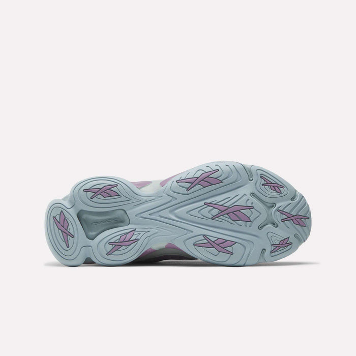 The image displays the light blue outsole of Reebok Women's DMX Series 3000 Training Shoes with wavy grooves, purple accents, and DMX 3 Technology for comfort, viewed from the bottom against a plain white background.