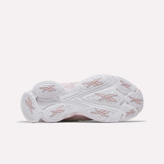 The image displays the sole of the Reebok Women's DMX Series 3000 Training Shoes, featuring a predominantly white base with subtle light pink accents and textured grip patterns. Photographed against a plain light background, this innovative design exemplifies the comfort and style characteristic of Reebok's footwear, making it ideal for everyday training and active wear.