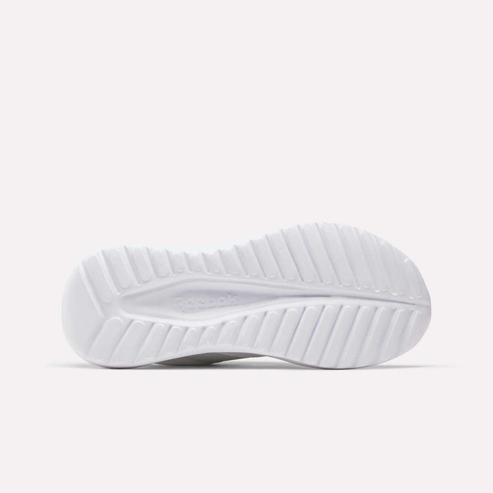 The white sole of the Reebok Women's Energen Lux Running Shoes, designed with a ridged, textured tread for grip and flexibility, is photographed against a plain light background.