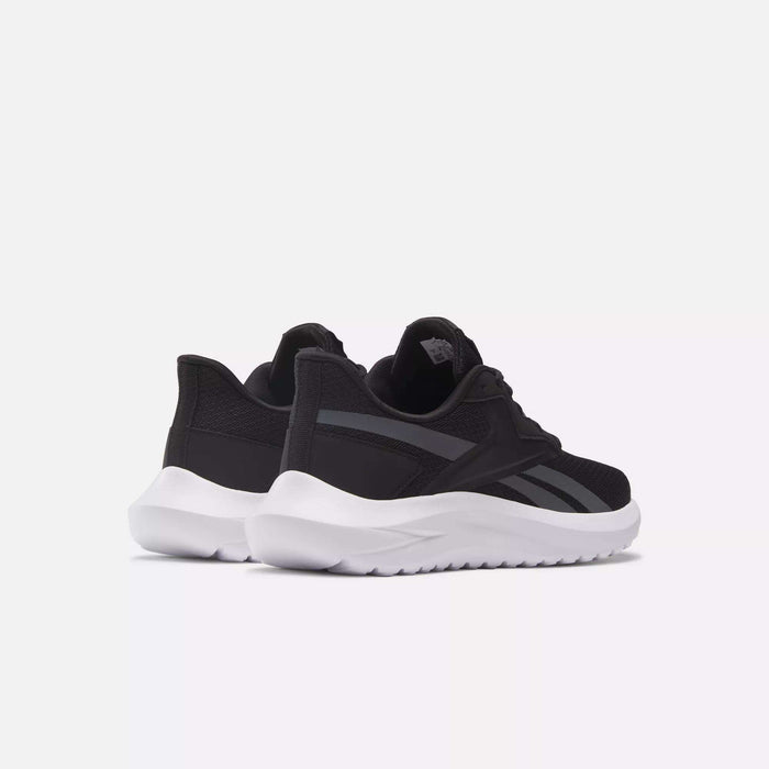 Reebok Women's Energen Lux Running Shoes are black with white thick soles, shown side by side on a light gray background from the back and side. These versatile sneakers feature a black mesh upper with dark gray accents and laces.