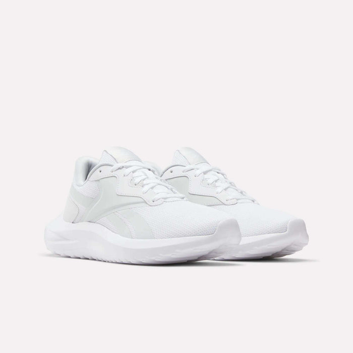 A pair of Reebok Women's Energen Lux Running Shoes with mesh uppers, white laces, and thick white soles is displayed on a plain light background.