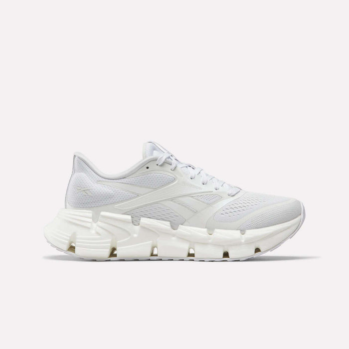 The Reebok Women's FloatZig 2 Running Shoes feature a white breathable mesh upper, tonal laces, and a sculpted rubber sole with Superfloat+ cushioning, shown in side profile on a plain white background.