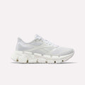 The Reebok Women's FloatZig 2 Running Shoes feature a white breathable mesh upper, tonal laces, and a sculpted rubber sole with Superfloat+ cushioning, shown in side profile on a plain white background.