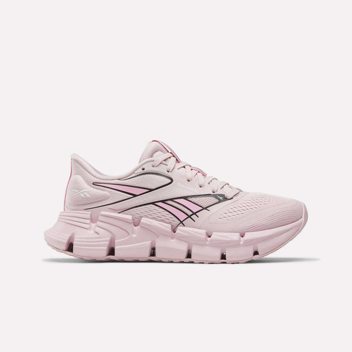 The Reebok Women's FloatZig 2 Running Shoes in Elemental Pink/Expressive Pink/Digital L feature a mesh upper, thick segmented Superfloat+ cushioned sole, dark accent lines, and a Reebok logo by the heel—ideal for springy runs.