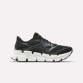 The Women's FloatZig 2 Running Shoes by Reebok are black, feature mesh and synthetic overlays, a chunky white segmented sole with Superfloat+ cushioning, and are shown from the side on a plain white background.