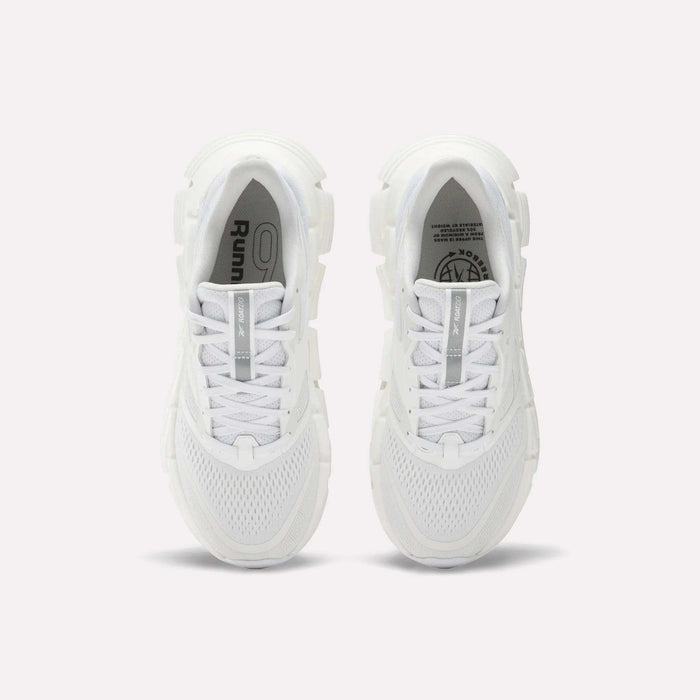 A pair of Women's FloatZig 2 Running Shoes by Reebok viewed from above, featuring white mesh uppers, chunky Superfloat+ cushioned soles, and white laces. The insoles show Reebok branding and graphic details.
