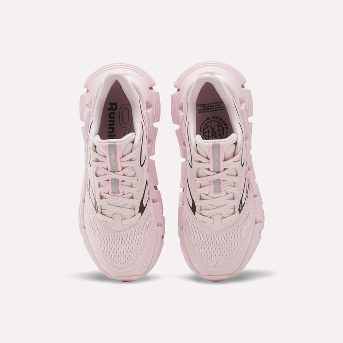 A pair of Women's FloatZig 2 Running Shoes by Reebok in light pink, seen from above with mesh uppers, chunky soles with Superfloat+ cushioning, and light blue and pink striped laces, displayed on a white background.