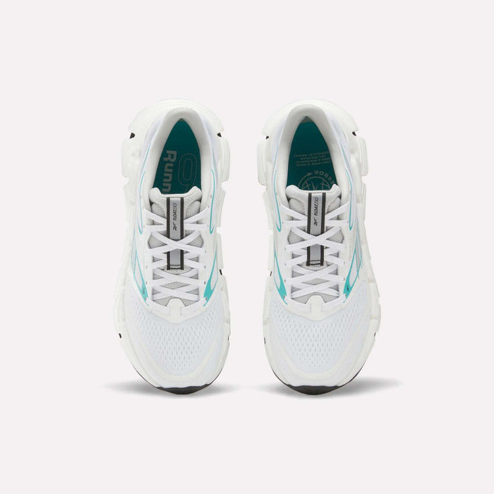 Top view of a pair of white Reebok Women's FloatZig 2 Running Shoes with turquoise accents and black soles on a plain white background. The insoles feature branding and design details, highlighting their springy cushioning.
