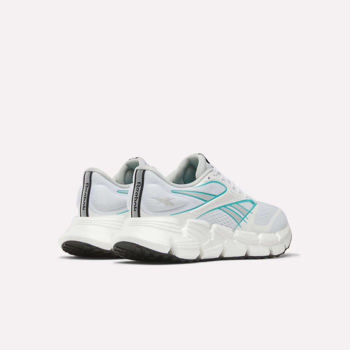 Women's Reebok FloatZig 2 Running Shoes in white with teal and silver accents, Superfloat+ cushioning, chunky soles, supportive upper, and black tread—shown from the back and side on a plain white background.