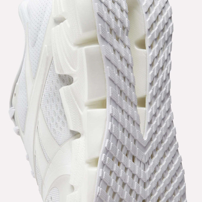 Close-up view of the sole and side of the Reebok Women's FloatZig 2 Running Shoes, featuring a textured tread pattern, breathable mesh upper, and signature Superfloat+ cushioning for enhanced comfort.