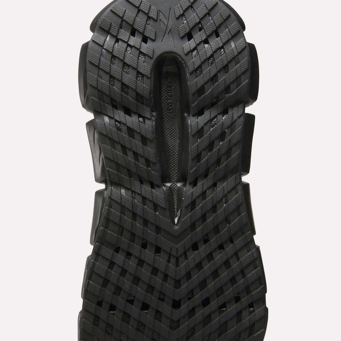 Close-up of a black sole on Reebok Women's FloatZig 2 Running Shoes, showcasing a textured grid pattern with raised sections for traction and energy-returning Superfloat+ cushioning inspired by high-performance running footwear.