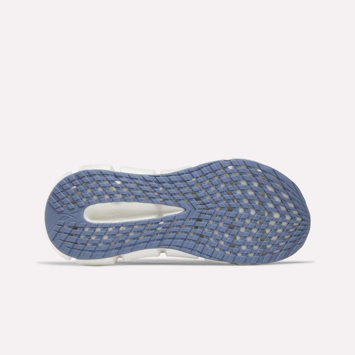 The image displays the sole of a women's Reebok FloatZig 2 Running Shoe with a textured blue pattern, white midsection, and central cutout design—highlighting its cushioning—against a plain white background.