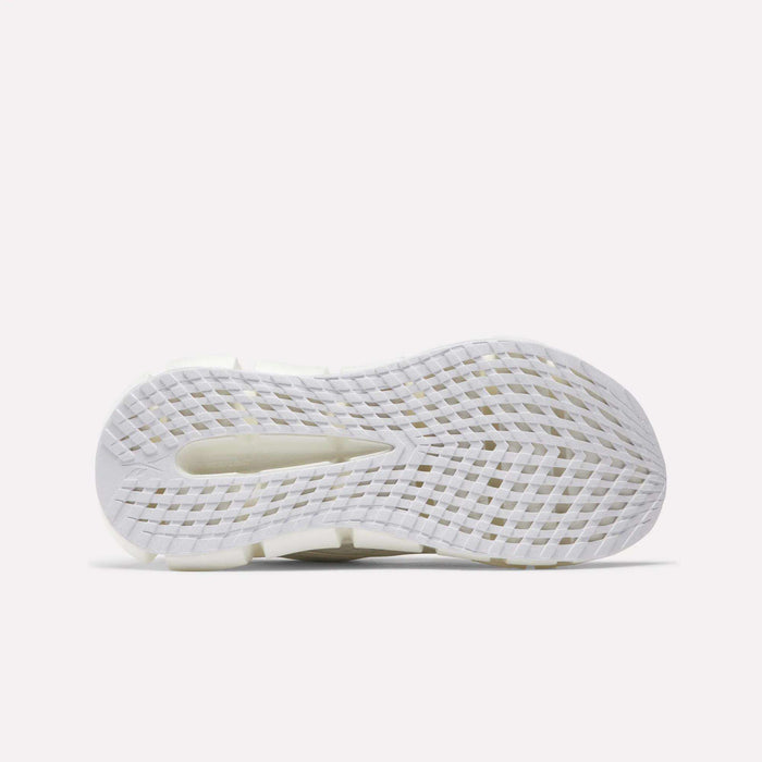 The image displays the white, textured sole of Reebok Women's FloatZig 2 Running Shoes. It features a grid-like traction pattern, a heel cutout, and Superfloat+ cushioning against a plain light background.