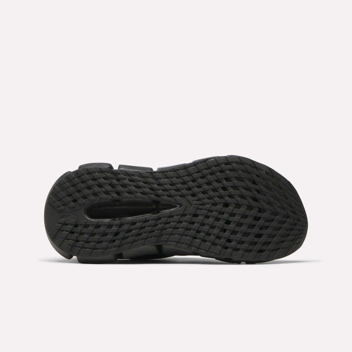The image shows the bottom view of the Reebok Women's FloatZig 2 Running Shoes' black sole, featuring a textured, grid-like pattern and traction grooves with energy-returning Superfloat+ cushioning, set against a plain white background.