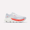 The Reebok Women's FloatZig Double Running Shoes in White/Grey/Red feature a modern, sporty design with breathable mesh, cushioned support, and bold red accents on the midsole and logo for stable comfort over long distances.