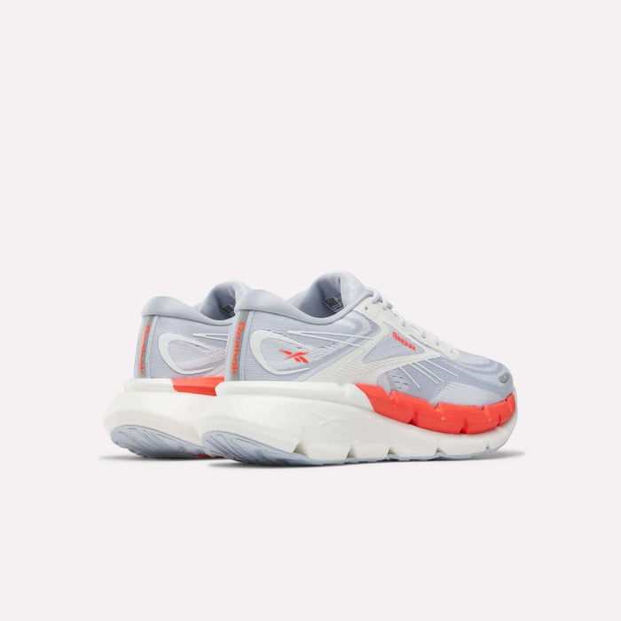 The Reebok Women's FloatZig Double Running Shoes feature cushioned support, light gray mesh uppers, white soles, and bright orange Zig accents for stability—displayed against a plain white background.