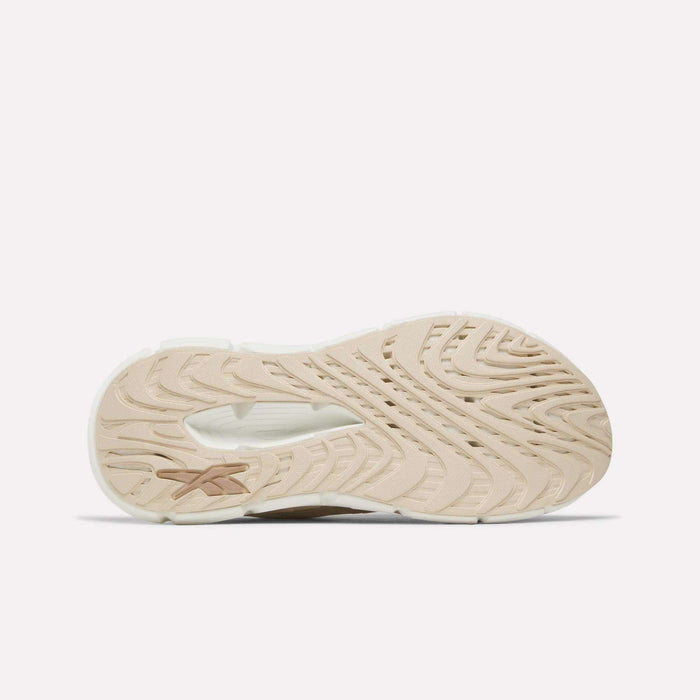 Beige and white textured sole of the Reebok Women's FloatZig Double Running Shoes, featuring wavy patterns and a small star-like logo, shown from the bottom against a plain white background.