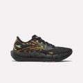 The Reebok Women's FloatZig Tread Running Shoes feature a breathable black mesh upper, vibrant orange and yellow flame patterns, neon yellow logo, plus orange accents—ideal for treadmill workouts.