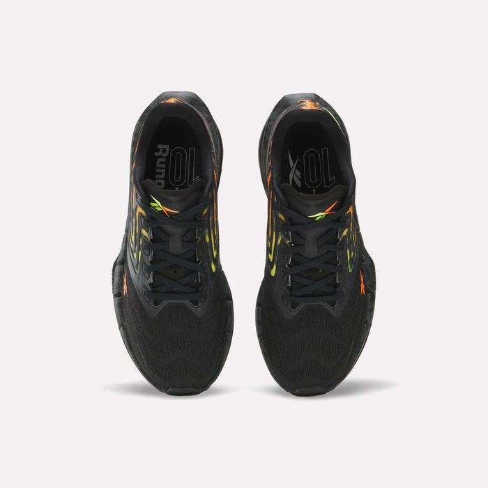 The Reebok Women's FloatZig Tread Running Shoes feature a black breathable mesh upper with neon yellow and orange accents. Seen from above on a white background, the insoles read "Run" and "10L," making them ideal for treadmill workouts.