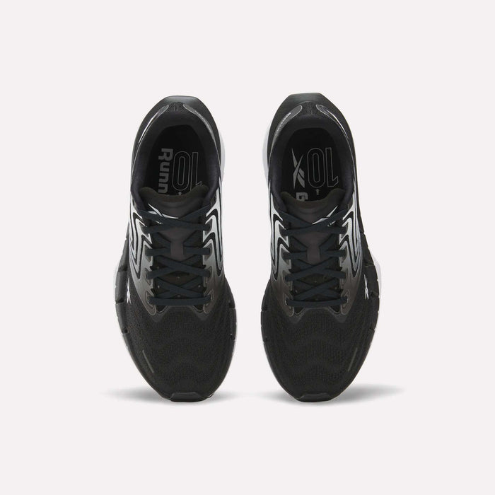Top view of Reebok Women's FloatZig Tread Running Shoes with white accents on a white background. Features breathable mesh uppers and branded insoles, ideal for treadmill workouts.