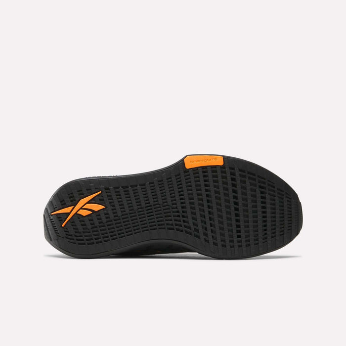 The black sole of the Reebok Women's FloatZig Tread Running Shoes features a textured grid, orange Reebok logo by the heel, and orange Griptonite label near the arch. Delivers perfect traction for treadmill workouts. White background.