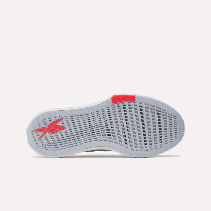 The image shows the sole of the Reebok Women's FloatZig Tread Running Shoes, mainly light gray with a grid-like tread and a red Reebok logo—crafted for treadmill workouts and comfort with breathable mesh.