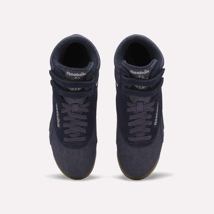 A pair of Reebok Women’s Freestyle Hi Shoes in navy blue, featuring white logos and gum soles, displayed from a top view on a plain light background.