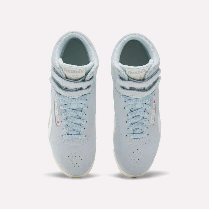 The Reebok Women's F/S Hi Shoes are light blue high top sneakers with suede uppers, white soles, perforated toes, and double Velcro straps at the top, shown from an overhead angle.