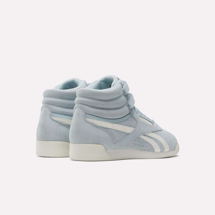 A pair of Women's F/S Hi Shoes by Reebok featuring a light blue suede upper, white soles, and white side stripes, shown from the back and side against a plain light background.
