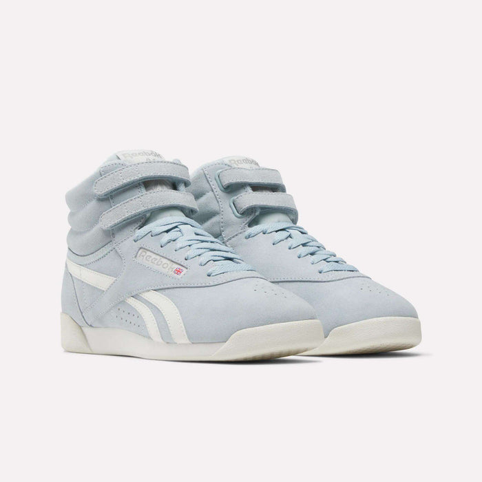 The Reebok Women's F/S Hi Shoes are light blue high tops featuring a suede upper, double velcro straps, white side stripes and accents, and off-white soles, shown on a plain white background.