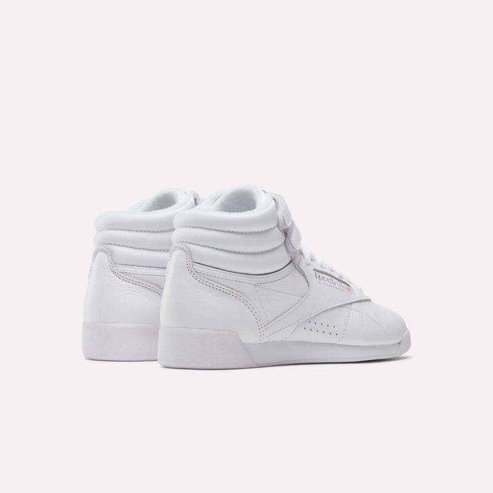 A pair of Reebok Women's Freestyle Hi Shoes with padded ankles and laces, placed side by side on a plain light background, viewed from behind at an angle—ideal for boosting your women's fitness look.